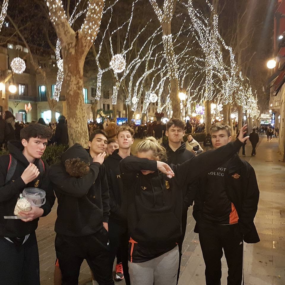 Team walking Palma's Passeig del Born under Christmas lights