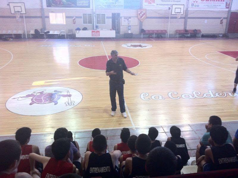 Diego Maggi speaking to players on court